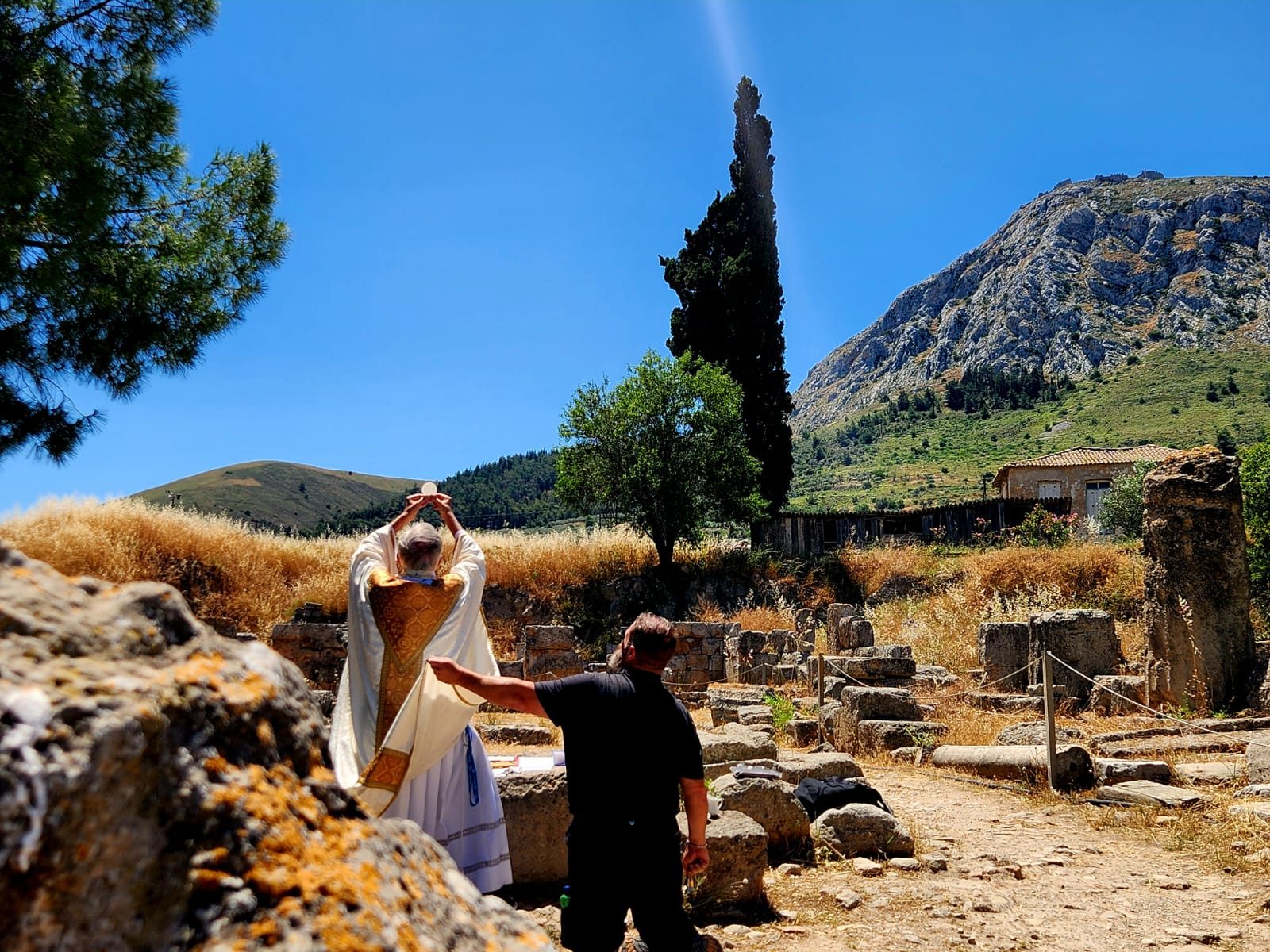Elevation of the Sacred Host at Mass in ancient Corinth, with the Acrocorinth in the background