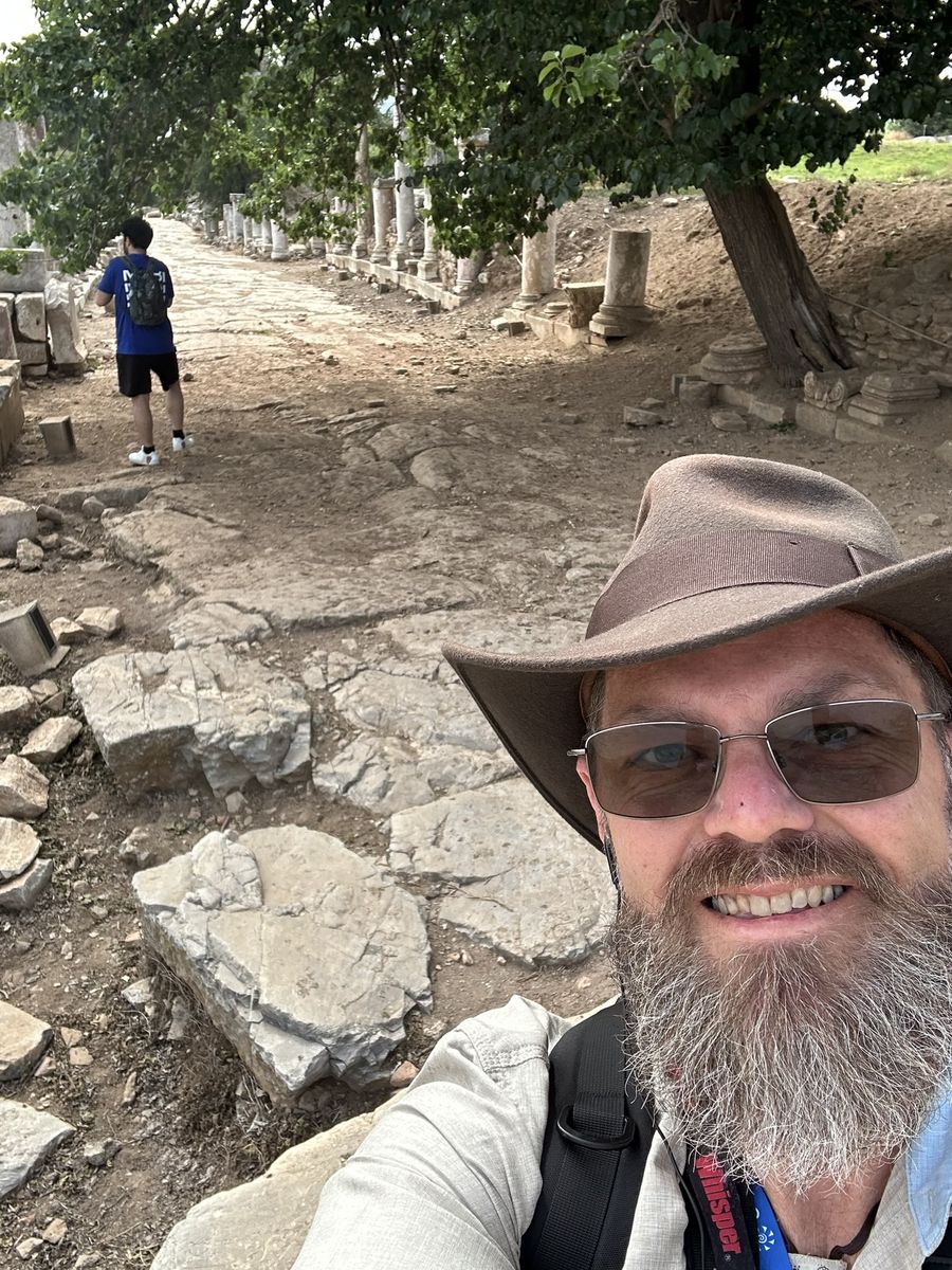Joe McClane walking an ancient colonnaded street