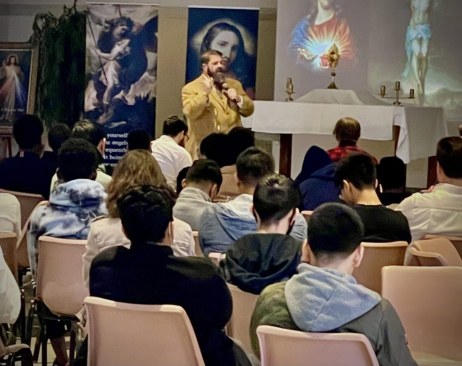 Joe McClane speaking to a room of young men at a Catholic retreat
