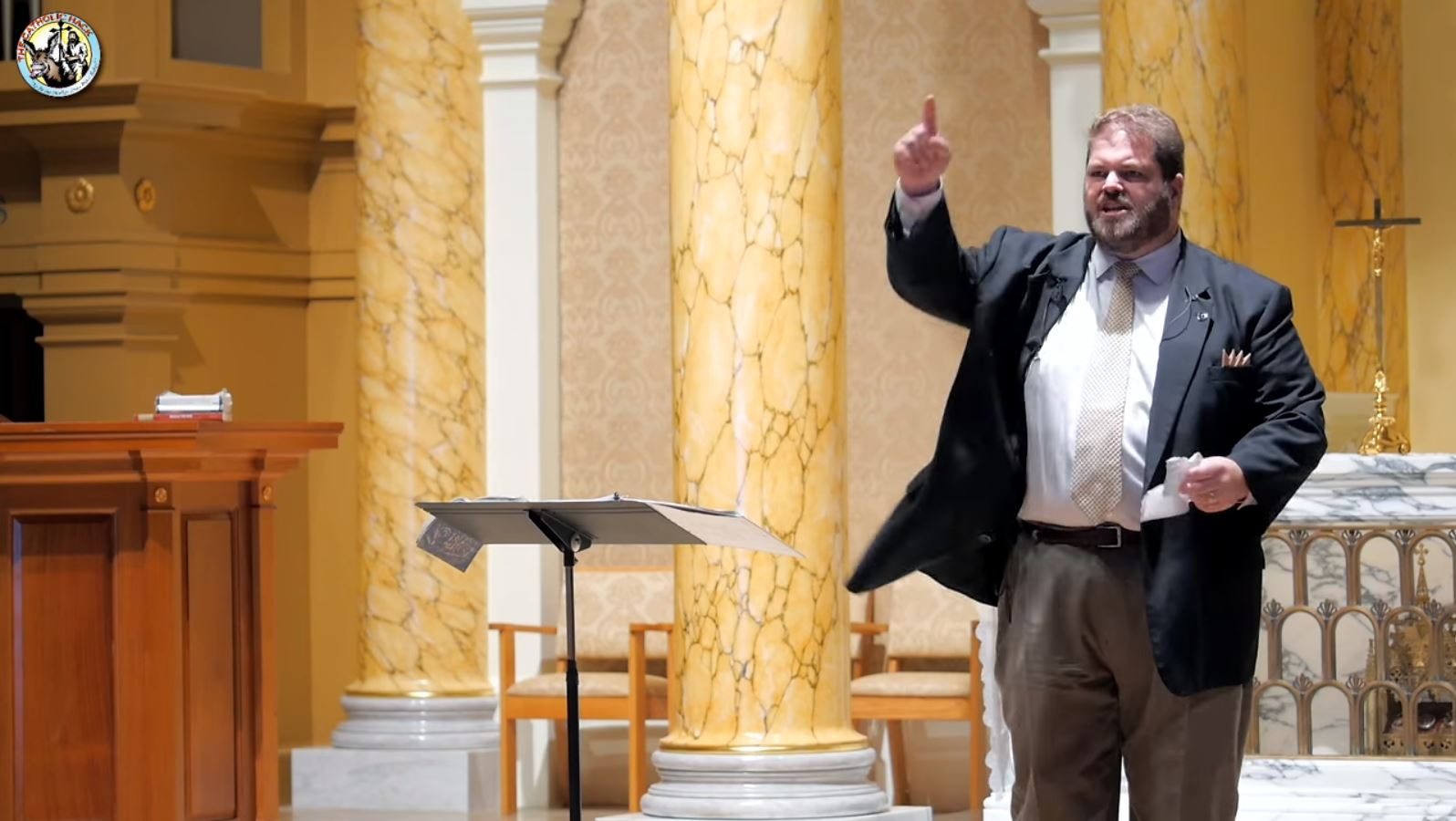Joe McClane preaching from the sanctuary at St. Theresa Catholic Church
